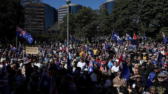 Reuters) Demonstrators carry Australian flags during the 'March for Australia' anti-immigration rally, in Sydney.