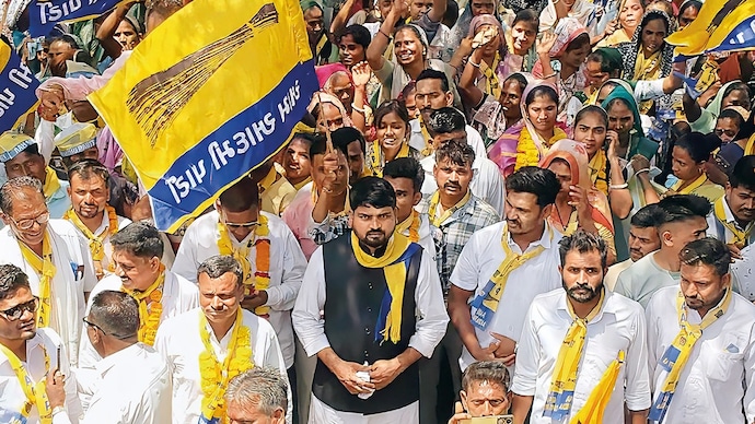 HOLDING OUT: (In dark coat) AAP MLA Chaitar Vasava at a roadshow, Apr. 10. (Photo: @Chaitar_Vasava/X)