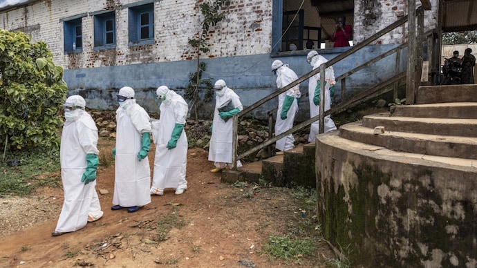 Health workers wearing protective equipment walk outside the General Referral Hospital during the Ebola outbreak response in Congo. (Photo: AFP) Health workers wearing protective equipment walk outside the General Referral Hospital during the Ebola outbreak response.