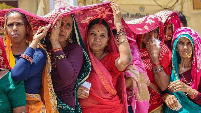 Women cover themselves to shield from the scorching heat on a hot summer day, in Rishikesh. (Photo: PTI) Heatwave alert
