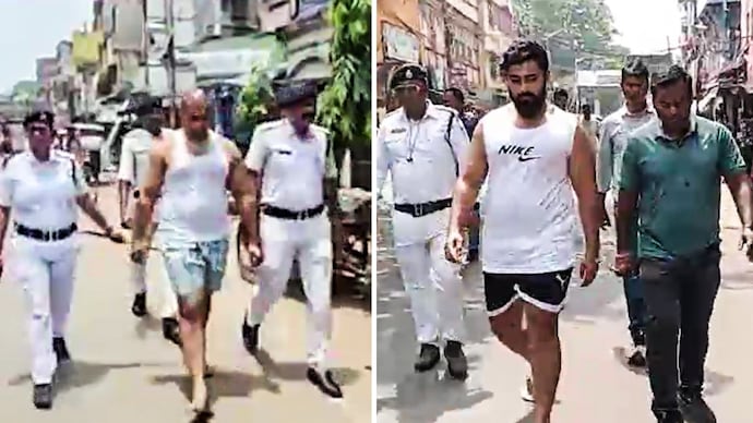 Howrah gangster Akash Singh (R) paraded in vest and underwear by police Howrah gangster Akash Singh (R) paraded in vest and underwear by police