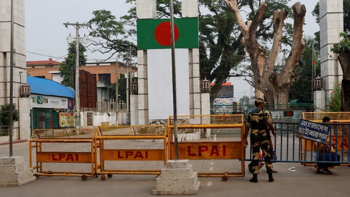 A Border Security Force (BSF) official stands in front of the gates of the India-Bangladesh border in Petrapole. (Photo: Reuters)