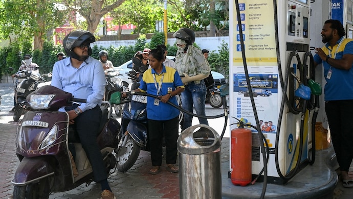 Motorists queue to fill fuel in their vehicles at a fuel station in Ahmedabad, soon after petrol and diesel prices were hiked by Rs 3/litre, on Friday. (Image: AFP) india fuel price hike can there be more rise in petrol diesel cost energy analysts prediction rs 3 oil manufacturing companies omc running in losses how much profit increase