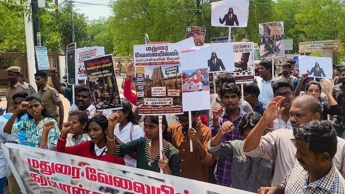 Members of the Democratic Youth Federation of India (DYFI) and Students' Federation of India (SFI) take out a procession holding placards with pictures of cockroaches. (Image: PTI)