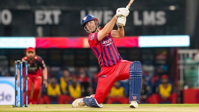 Mitchell Marsh smashed a 49-ball century against RCB. Courtesy: AFP Mitchell Marsh