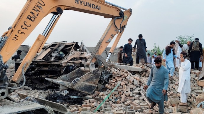 Residents gather on the rubble of a damaged police post after a car bombing in Bannu, Khyber Pakhtunkhwa province, Pakistan May 10, 2026. (Reuters photo) Pakistan Car Bomb