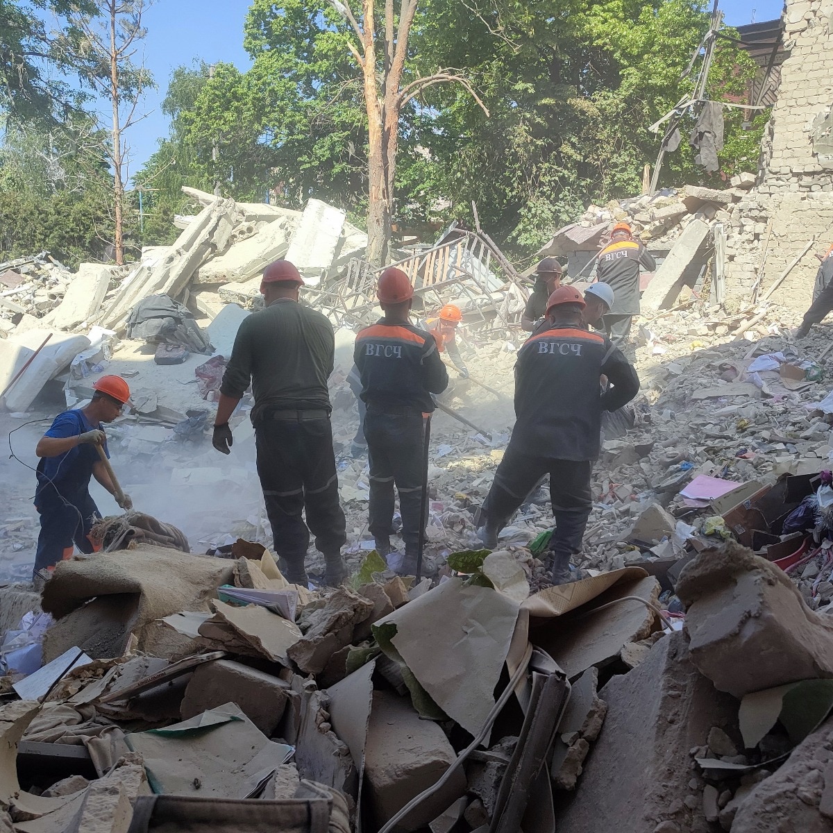 Rescuers work amid debris of a destroyed dormitory building of the Starobilsk College of Luhansk 