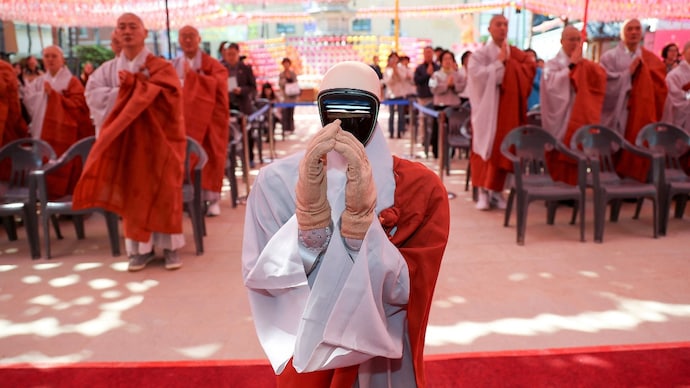 Humanoid robot Gabi folds its hands during a precept ceremony at a temple in Seoul, South Korea, May 6, 2026. Yonhap via REUTERS Robot monk Gabi south korea