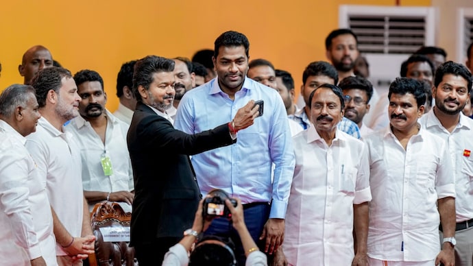 TVK chief C Joseph Vijay was sworn in as Tamil Nadu Chief Minister and later took a selfie with former national-level basketball player Aadhav Arjuna. (Image: PTI) Tamilaga Vettri Kazhagam (TVK) chief C Joseph Vijay takes oath as the Tamil Nadu Chief Minister during the swearing-in ceremony, at Jawaharlal Nehru Stadium, in Chennai, Sunday, May 9, 2026.