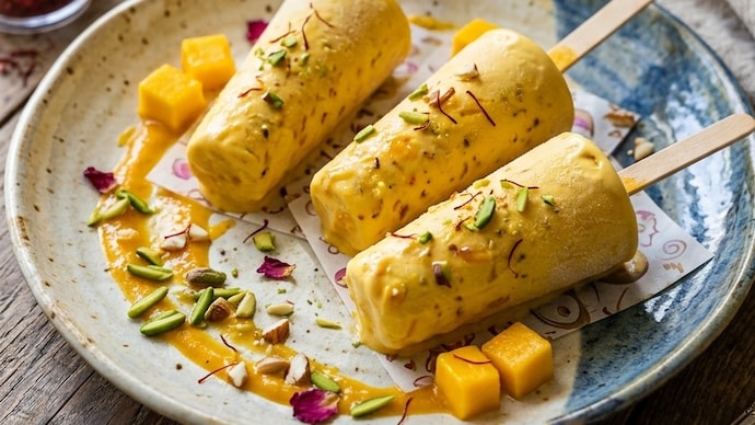 This easy mango kulfi recipe brings restaurant-style flavour home with mango pulp, milk and cream. Follow these simple steps to make a rich frozen Indian dessert this summer. (AI generated image) This easy mango kulfi recipe brings restaurant-style flavour home with mango pulp, milk and cream. Follow these simple steps to make a rich frozen Indian dessert this summer. (AI generated image)