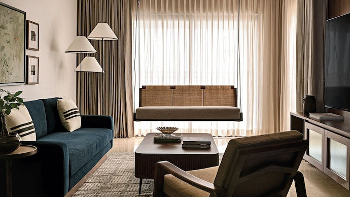 MODERN NOSTALGIA: A custom rattan-backed swing lends the living room a sense of nostalgia | Photograph by Nayan Soni
