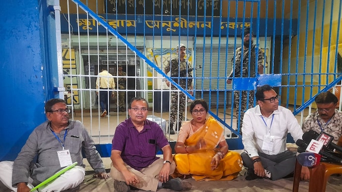 TMC candidates Kunal Ghosh (second from left) and Shashi Panja (centre) and others stage a sit-in outside a strongroom at Khudiram Anushilan Kendra in Kolkata on Thursday. (Photo: PTI)