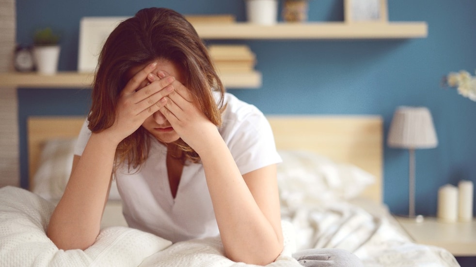 Unhappy girl in a bedroom