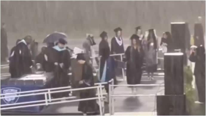 US students brave heavy rain at graduation ceremony to receive diplomas