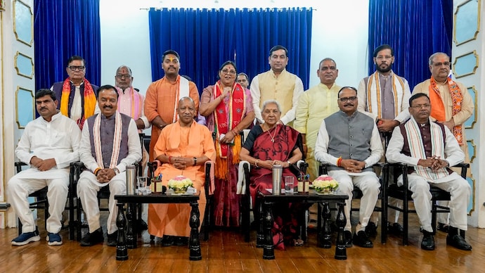 Uttar Pradesh Governor Anandiben Patel, Chief Minister Yogi Adityanath, his Deputies Keshav Prasad Maurya and Brajesh Pathak with newly-inducted ministers. (Photo: PTI) Uttar Pradesh Governor Anandiben Patel, Chief Minister Yogi Adityanath, his Deputies Keshav Prasad Maurya and Brajesh Pathak with newly-inducted ministers. (Photo: PTI)