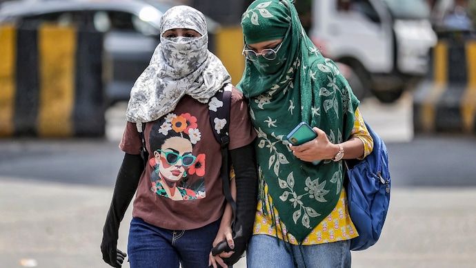 Women cover themselves on a hot summer day, in Jaipur. (Photo: PTI) Women cover themselves on a hot summer day, in Jaipur