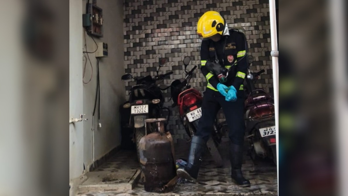 A firefighter inspecting the cylinder damaged in the blast.