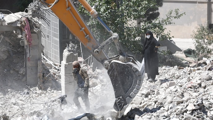 A woman stands amid the rubble of her home, damaged in a US strike in Iran. (Reuters) A woman stands amid the rubble of her home, damaged in a US strike in Iran. (Reuters)
