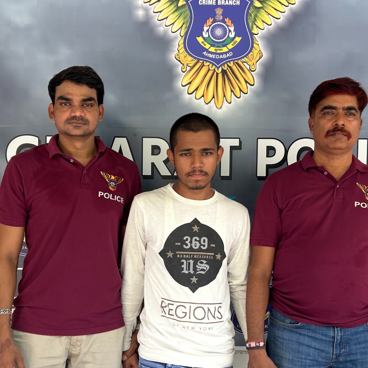 Ahmedabad Police officials with the arrested accused Naveen Yadav. 