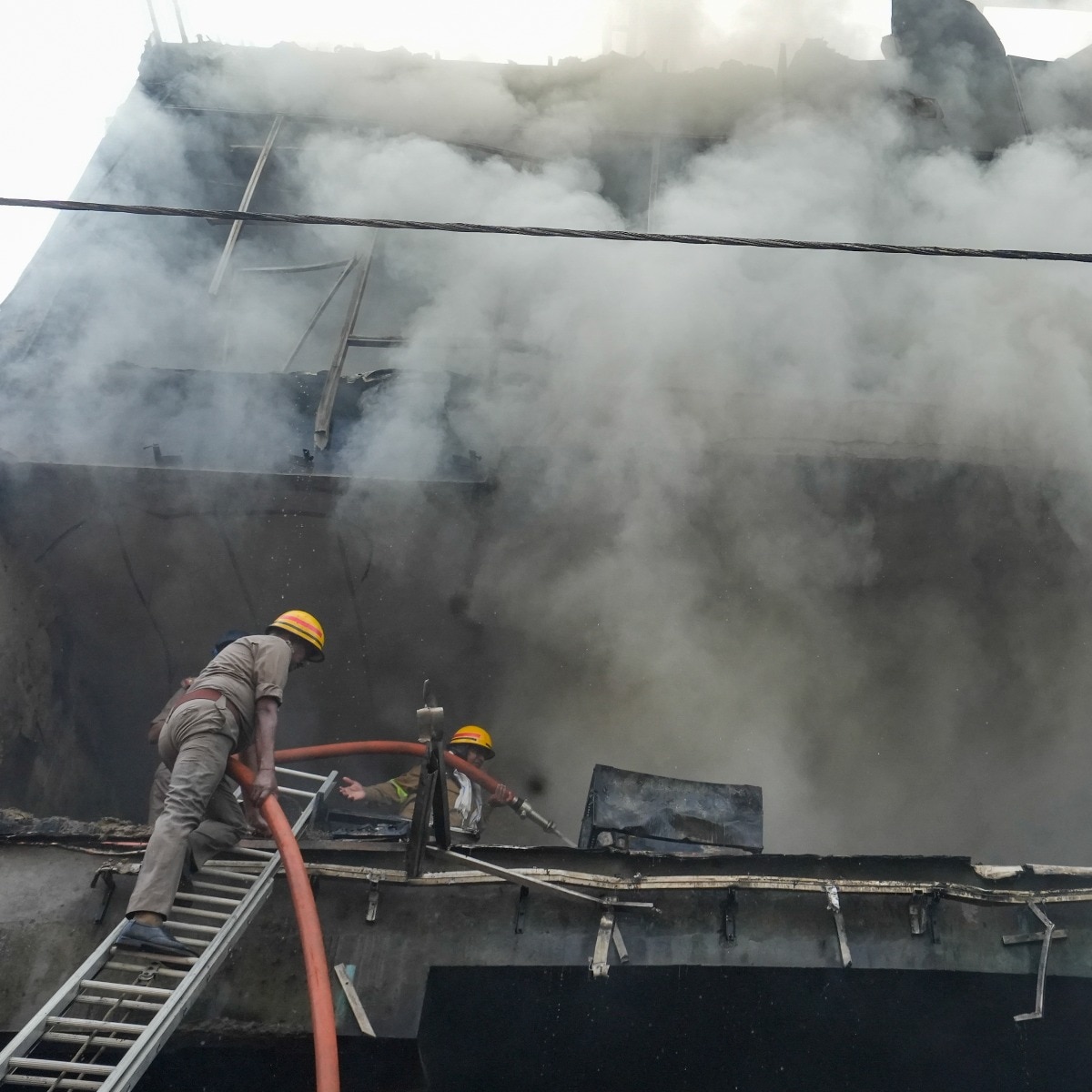 Fire personnel conduct a dousing operation after fire broke out at a commercial building in Aliganj. Students were killed after a massive fire blazed through a three-floor commercial building in a residential area (PTI Photo)