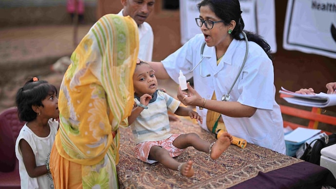 Although children under five make up just 9% of the world's population, they account for almost one-third of all foodborne diseases globally. (Photo: Getty Images) In a rural health care camp, a picture captures a crucial moment as a female doctor administers polio dosage to a child.