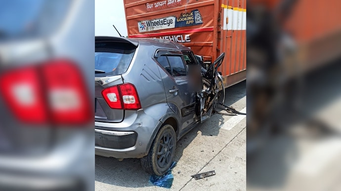 The car was completely mangled after it crashed into container truck.