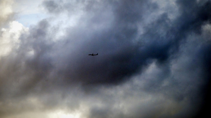 An aircraft flies over monsoon clouds above the city skyline on a rainy day. (Photo: PTI) Monsoon covers peninsular India, conditions favourable for further advance