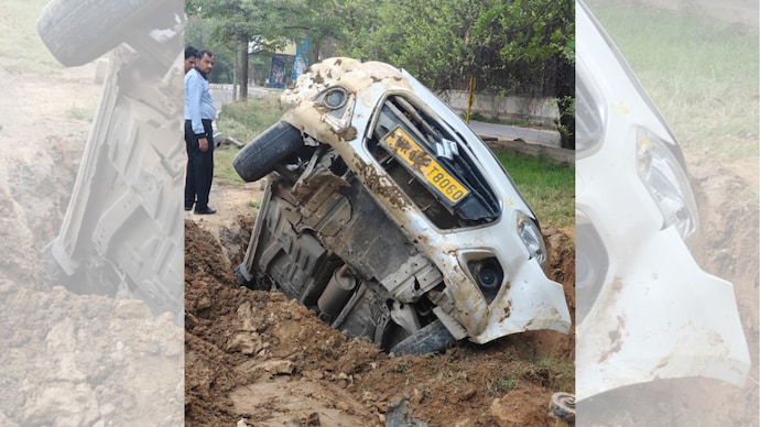 Open pit swallows car in Greater Noida, driver has miraculous escape. Open pit swallows car in Greater Noida, driver has miraculous escape.