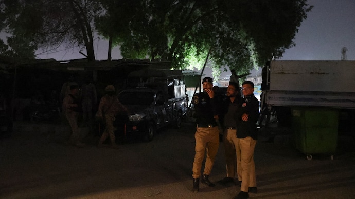 Security personnel stand guard after an explosion and gunfire were reported, near offices of the Rangers in Karachi. (Reuters photo)