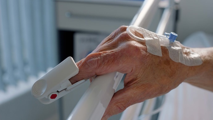 Delhi blaze spotlights deadly asphyxiation risk Person, finger and heart rate monitor in hospital for hypertension, blood pressure or diabetes. Hand, bed and glucose test for consultation in clinic for failure pulse disease, diagnosis or device