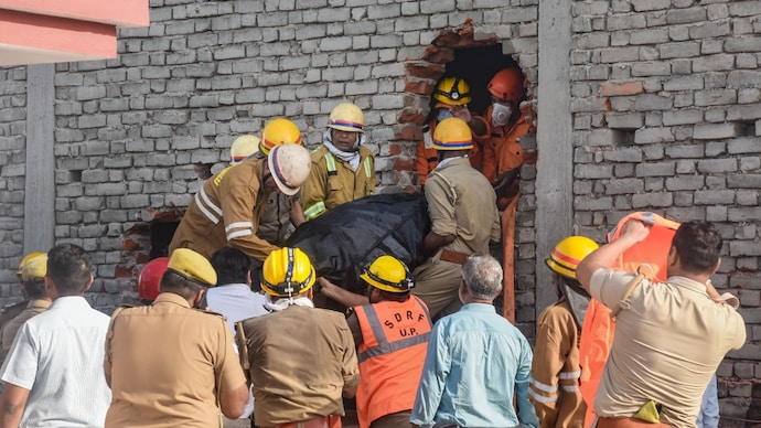 Rescue personnel conduct rescue operations after fire broke out at a commercial building in Lucknow. Students were killed after a massive fire blazed through a three-floor commercial building in a residential area. (PTI Photo)
