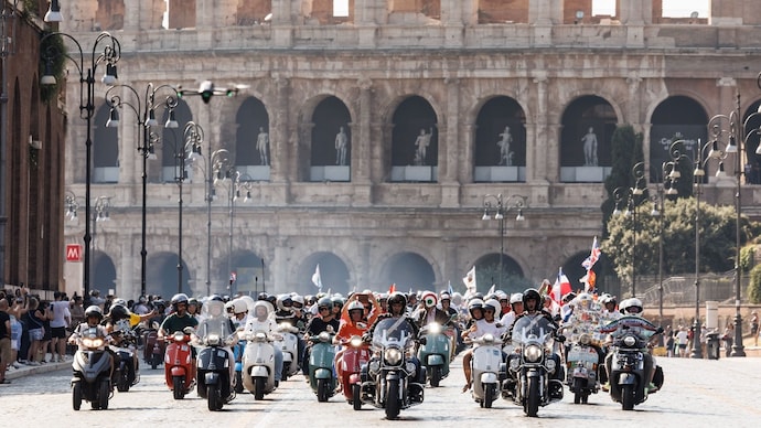 Thousands of Vespa riders from 67 countries parade through the streets of Rome during the largest-ever Vespa rally, celebrating the iconic Italian scooter's 80th anniversary.