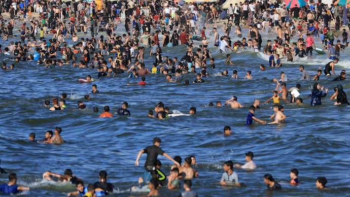 To survive heatwave in tents, Gazans are running to polluted Mediterranean Sea