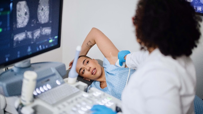 A young woman is doing a breast ultrasound for preventive breast cancer care