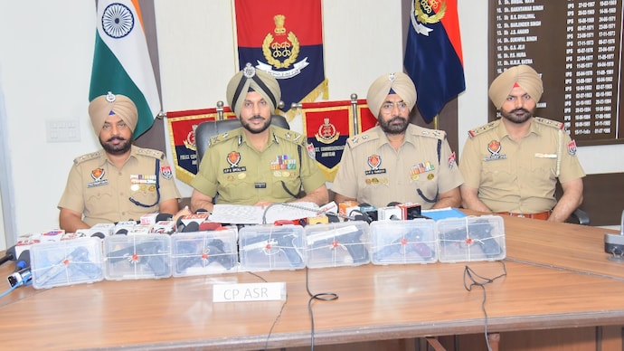 Amritsar Police officials with the confiscated arms.