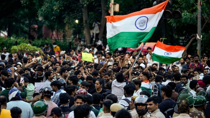 CJP supporters wave the national flag during a protest demanding the resignation of Union Education Minister Dharmendra Pradhan in New Delhi on Thursday. (Photo: PTI)