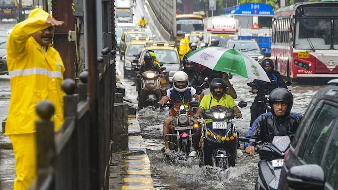 Commuters in Mumbai wade through a waterlogged road after heavy rainfall. (PTI image for representation)