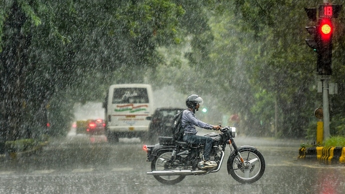 A man rides a bike amid heavy rainfall. (Photo: PTI) Delhi on red alert: Heavy rain batters capital, monsoon turns vigorous