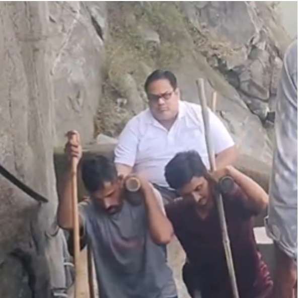 4 men carrying devotee uphill revisits 'humans carrying humans' debate