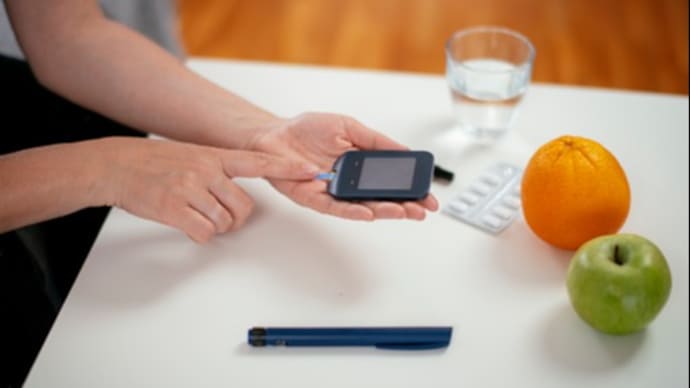 Diabetes doing blood glucose measurement stock photo. Shadow DOF. Developed from RAW; retouched with special care and attention; Small amount of grain added for best final impression. 16 bit Adobe RGB color profile.