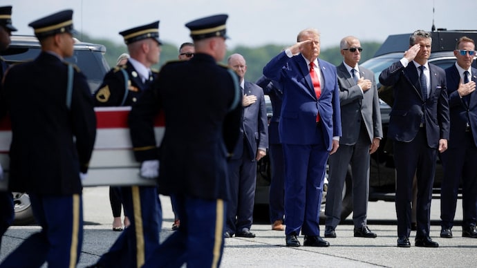 US President Donald Trump and Secretary of Defense Pete Hegseth salute during the dignified transfer of the remains of four US soldiers killed in the Iran war at Dover Air Force Base in Delaware.