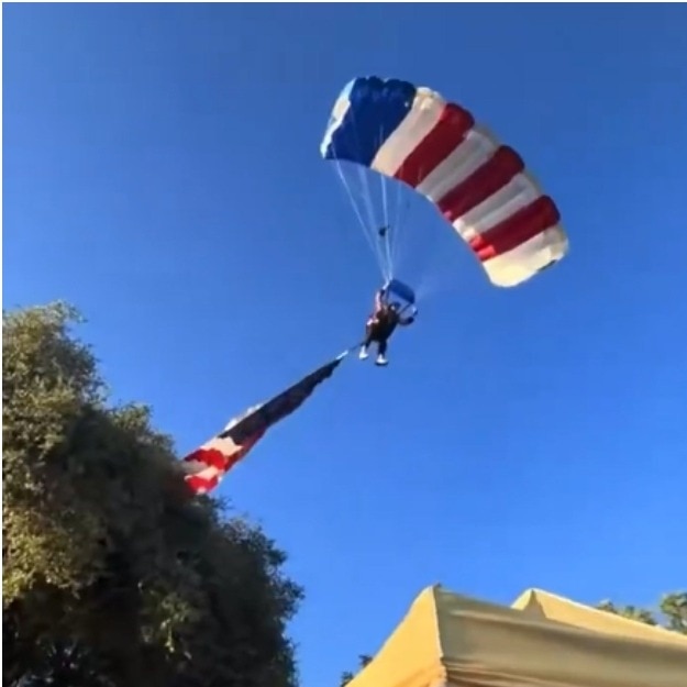 US skydiver carrying huge flag crashes into rodeo tent, walks away unhurt