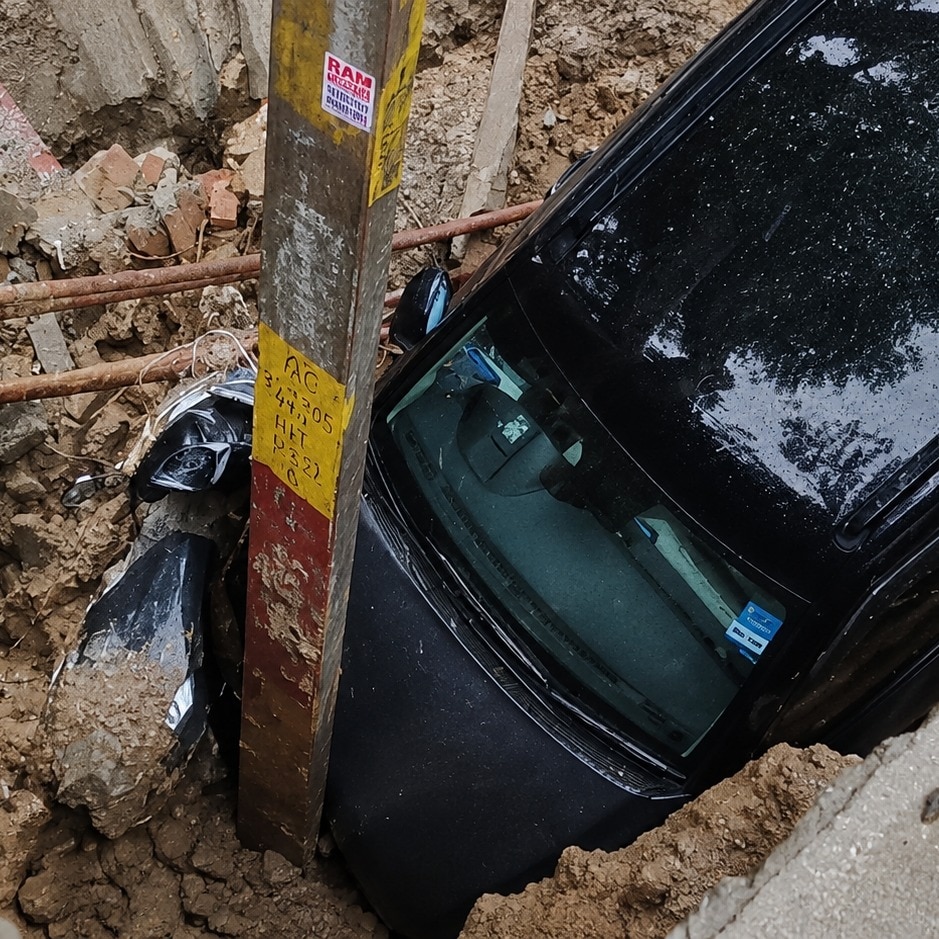 Video: Ghaziabad road caves in amid heavy rain, car and scooter fall into ditch