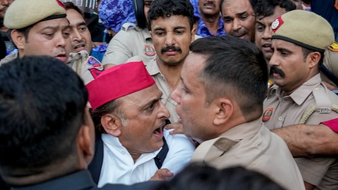 Law enforcement personnel on Tuesday detain SP chief Akhilesh Yadav near the Prime Minister's residence. (PTI Image)