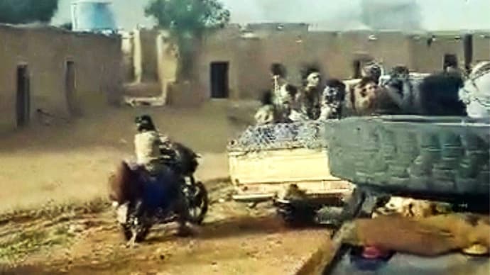 Militants ride in vehicles after chant "God is Great" in Anefis, Mali, as gunshots ring out. (Reuters)
