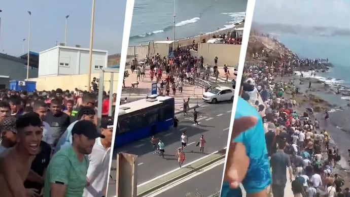 Migrants run and cheer as they cross on foot into the North African enclave of Ceuta from Morocco. (Photo: Reuters)