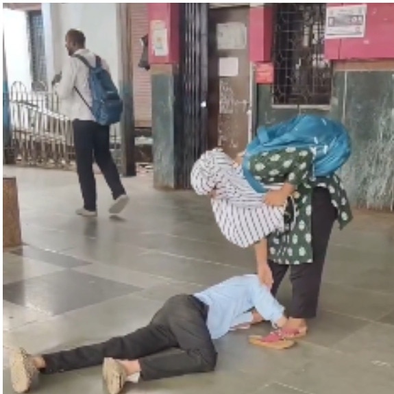 Mumbai man lies on railway platform, holds woman's feet as cops step in