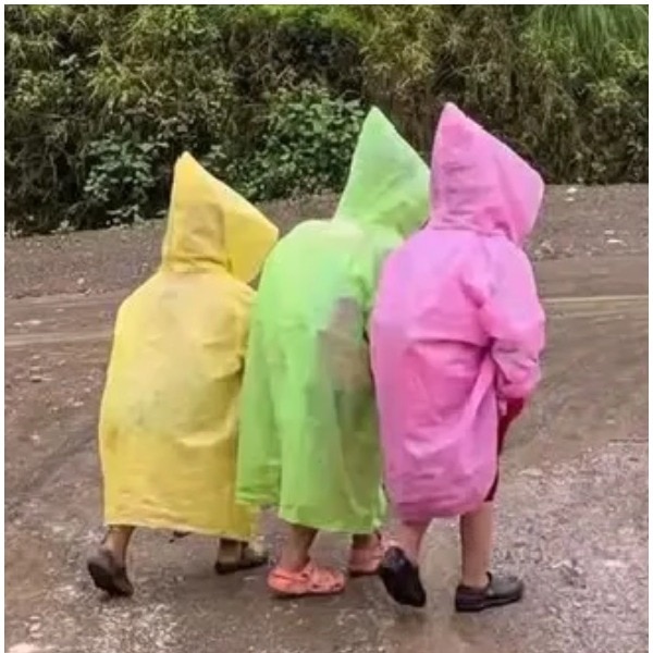 Nepal schoolchildren in raincoats walk uphill hand-in-hand, sight is too cute to miss