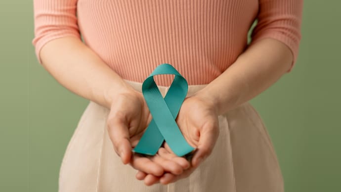 Ovarian and Cervical Cancer Awareness. Woman Holding Teal Ribbon on Lower Abdomen, Uterus, Female Reproductive System, Women's Health, PCOS and Gynecology