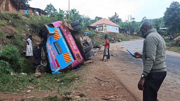 People stand near the wreckage of a bus, owned by King David Junior School People stand near the wreckage of a bus, owned by King David Junior School
